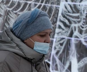 epa08911516 A visitor wearing a protective face mask attends the ice sculptures Christmas festival 'Fairy Tales of Planet Earth' amid the coronavirus Covid-19 pandemic in Podolsk, outside Moscow, Russia, 30 Dcember 2020. Russians are preparing to celebrate New Year's Eve on 31 December and Christmas which is observed on 07 January according to the Russian Orthodox Julian calendar, 13 days after Christmas on 25 December on the Gregorian calender.  EPA/MAXIM SHIPENKOV