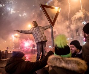 epa08913478 A combination picture shows an almost empty Wenceslas Square, the usual place of celebrations, during the curfew on New Year's Eve in Prague, Czech Republic, 31 December 2020 (top), and New Year's Eve celebrations at Wenceslas Square in Prague, Czech Republic, 01 January 2017 (bottom). The Czech government has implemented a curfew from 9pm to 5am, starting on 27 December 2020, and another restrictions in an effort to stop the spread of the COVID-19 disease.  EPA/MARTIN DIVISEK