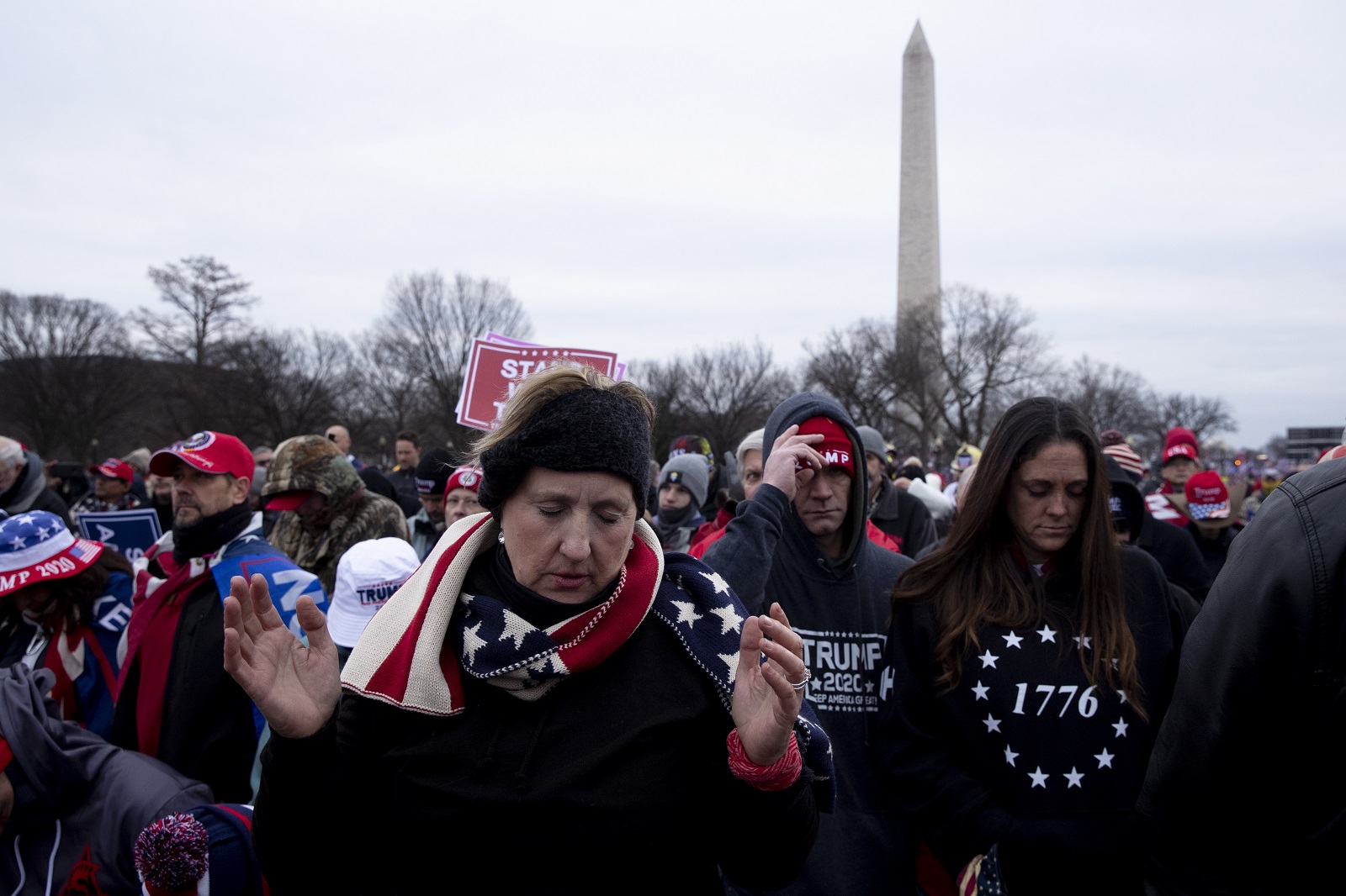 epa08922397 Supporters of US President Donald J. Trump pray at a rally on the Ellipse near the White House in Washington, DC, USA, 06 January 2021. Right-wing conservative groups are protesting against Congress counting the electoral college votes. Dozens of state and federal judges have shot down challenges to the 2020 presidential election, finding the accusations of fraud to be without merit.  EPA/MICHAEL REYNOLDS