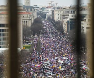 epa08923280 Supporters of US President Donald J. Trump and his baseless claims of voter fraud march down Pennsylvania Avenue as they breach Capitol security and climb the inauguration stand to protest Congress certifying Joe Biden as the next president in Washington, DC, USA, 06 January 2021.  EPA/JIM LO SCALZO