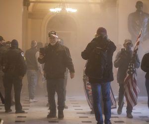 epa08923435 Supporters of US President Donald J. Trump are seen in statuary hall amidst tear gas after breaching Capitol security in Washington, DC, USA, 06 January 2021. Protesters entered the US Capitol where the Electoral College vote certification for President-elect Joe Biden took place.  EPA/JIM LO SCALZO