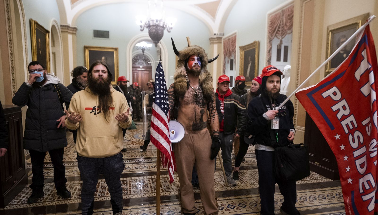 epa08923457 Supporters of US President Donald J. Trump stand by the door to the Senate chambers after they breached the US Capitol security in Washington, DC, USA, 06 January 2021. Protesters stormed the US Capitol where the Electoral College vote certification for President-elect Joe Biden took place.  EPA/JIM LO SCALZO