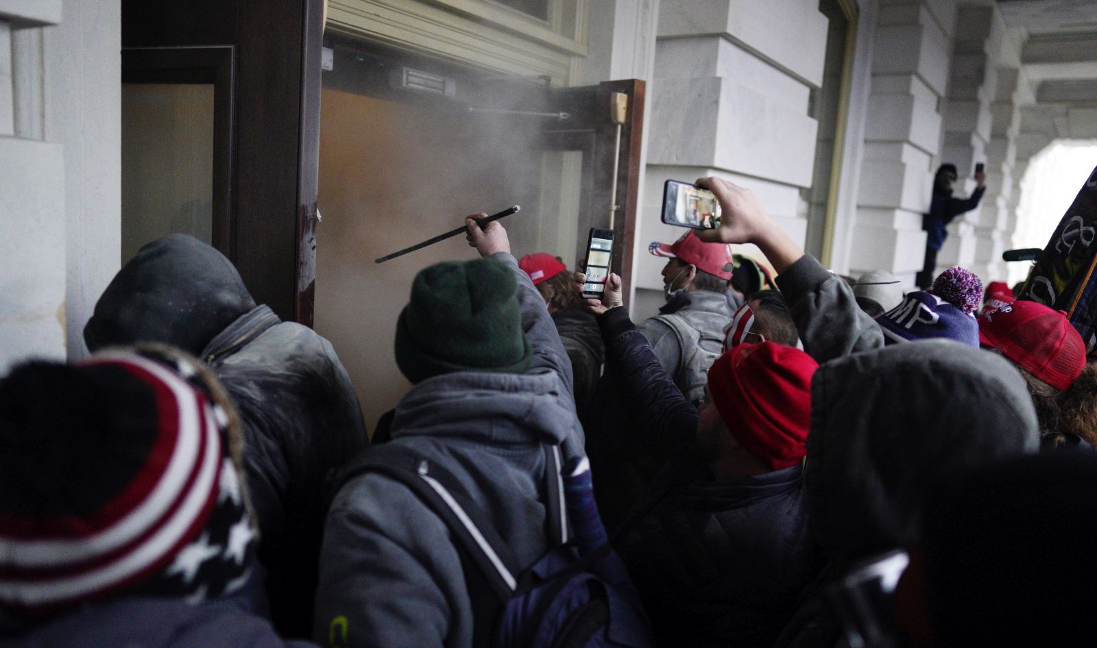 epa08923665 Pro-Trump protesters are pepper sprayed as they attempt to storm the grounds of the US Capitol, in Washington, DC, USA, 06 January 2021. Various groups of Trump supporters have broken into the US Capitol and rioted as Congress prepares to meet and certify the results of the 2020 US Presidential election.  EPA/WILL OLIVER