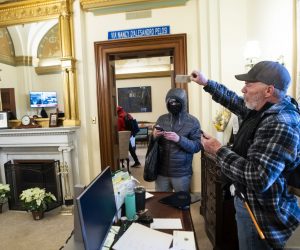 epa08926296 Richard Bigo Barnett (R), a supporter of US President Donald J. Trump and his baseless claims of voter fraud, takes an envelope off a desk in the office of Speaker of the House Nancy Pelosi after breaching Capitol security during a protest against Congress certifying Joe Biden as the next president in Washington, DC, USA, 06 January, 2020 (issued 08 January 2020). On 08 January Assistant House Speaker Katherine Clarke said the House will move to impeach President Trump if the Vice President and Cabinet do not remove him on their own.  EPA/JIM LO SCALZO