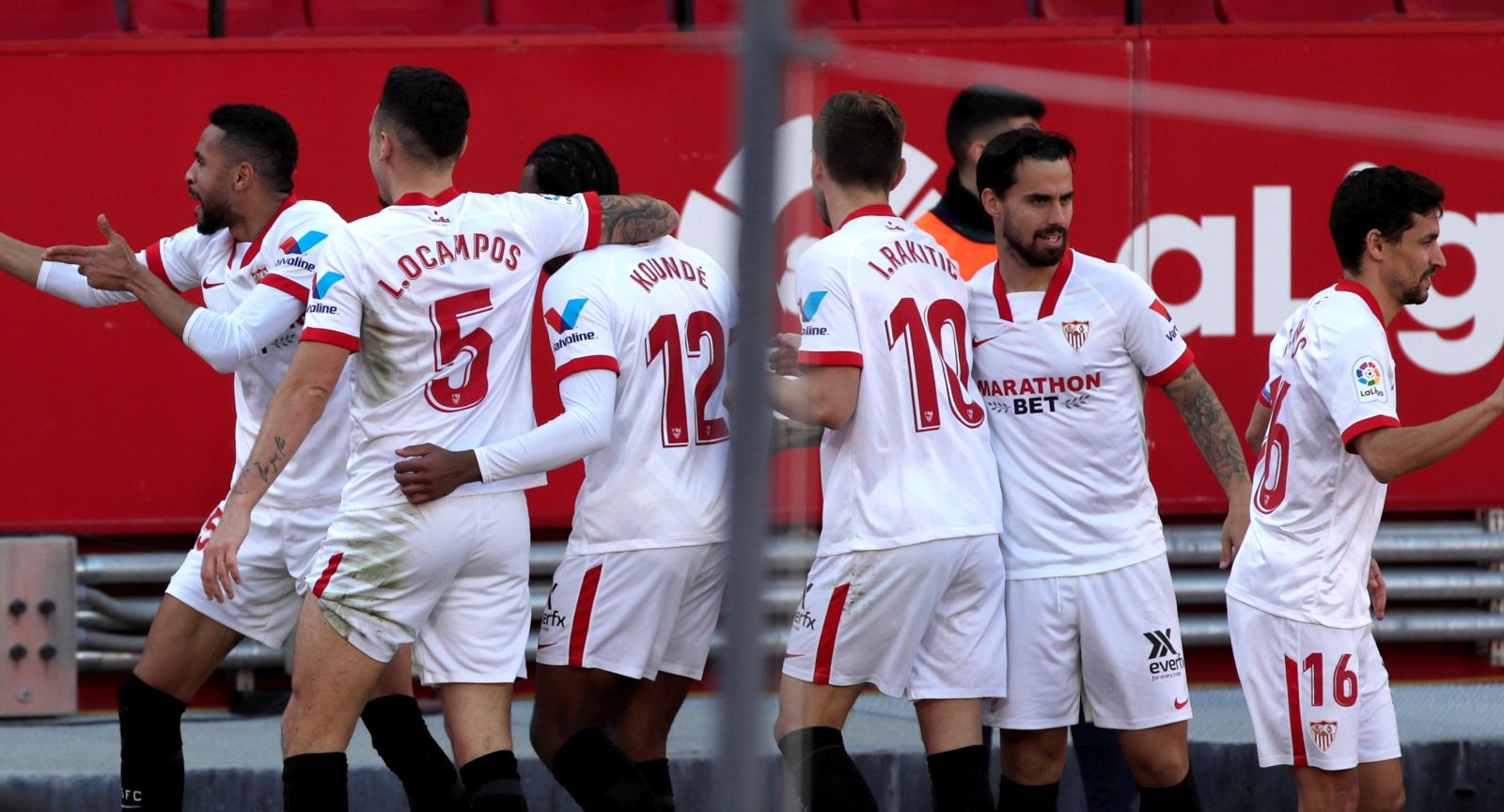 epa08928472 Sevilla's Youssef En-Nesyri (L) celebrates with teammates after scoring the 3-2 goal during the Primera Division LaLiga match held between Sevilla and Real Sociedad in Seville, Spain, at Sanchez Pizjuan stadium, 09 January 2021.  EPA/Julio Munoz