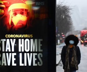 epa08934330 A public health notice to 'stay home' is seen at a bus stop in London, Britain, 13 January 2021. Britain's National Health Service (NHS) is under intense pressure as Covid-19 hospital admissions continue to rise across the UK. Every day, around a thousand people die from the disease.  EPA/ANDY RAIN