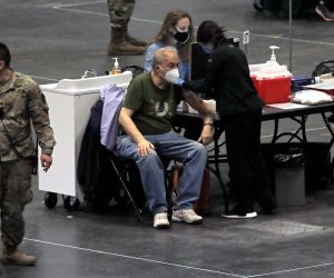 epa08935556 A man recieves a COVID-19 vaccination of the New York State Covid-19 Vaccination Site at the Jacob K. Javits Convention Center in New York, New York, USA, 13 January 2021. With the current CDC directive, seven million New Yorkers are now eligible for the vaccine.  EPA/PETER FOLEY