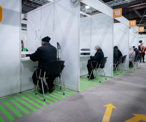 epa08936825 People arrive for their vaccination with Biontech/Pfizer vaccines against Covid-19 at Berlin's second vaccination centre at the Erika Hess ice stadium, Berlin, Germany, 14 January 2021.v  EPA/KAY NIETFELD / POOL