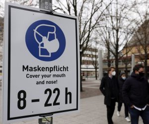 epa08937088 A sign demands wearing face masks at the shopping street 'Zeil' in Frankfurt am Main, Germany, 14 January 2021. Due to an increasing number of cases of the COVID-19 pandemic caused by the SARS CoV-2 coronavirus, nationwide restrictions have been introduced to counteract a rise in infections.  EPA/RONALD WITTEK