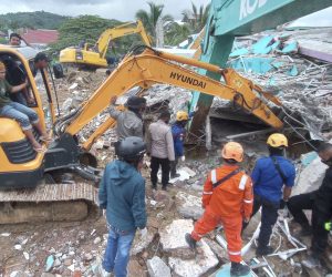 epaselect epa08938287 Indonesian rescue teams search for victims under the rubble of a collapsed building following a 6.2 magnitude earthquake in Mamuju, West Sulawesi, Indonesia, 15 January 2021. At least seven people were killed and hundreds injured.  EPA/STR