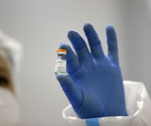 epa08948364 Medical worker wearing protective equipment prepares a dose of Sinopharm's China National Biotec Group COVID-19 vaccine during the vaccination at Belgrade Fair makeshift vaccination center in Belgrade, Serbia, 19 January 2021. Serbia began its mass vaccination against COVID-19 with elderly people and medical workers then moving on to members of the military and the police.  EPA/ANDREJ CUKIC