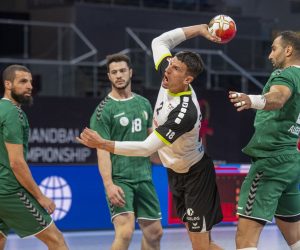 epa08962243 Switzerland's Andy Schmid (C) in action against Berriah Abderahim (R) of Algeria during the Main Round match between Algeria and Switzerland at the 27th Men's Handball World Championship in Cairo, Egypt, 24 January 2021.  EPA/URS FLUEELER