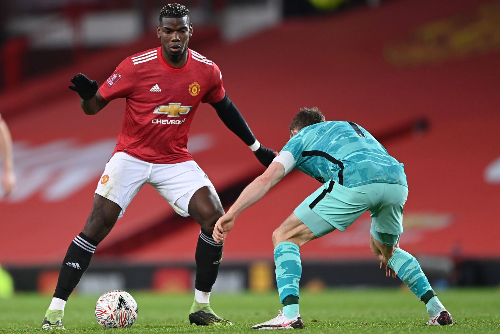 epa08962853 James Milner (R) of Liverpool in action against Paul Pogba (L) of Manchester United during the English FA Cup fourth round soccer match between Manchester United and Liverpool in Manchester, Britain, 24 January 2021.  EPA/Laurence Griffiths / POOL EDITORIAL USE ONLY. No use with unauthorized audio, video, data, fixture lists, club/league logos or 'live' services. Online in-match use limited to 120 images, no video emulation. No use in betting, games or single club/league/player publications.