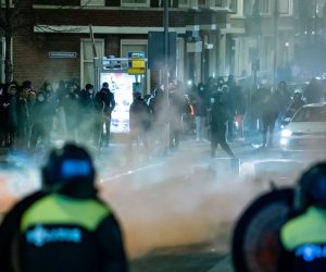 epa08965126 A large group of young people seeks confrontation with the police and pelts the police present with stones and fireworks on Beijerlandselaan in Rotterdam, The Netherlands, 25 January 2021. Police's mobile unit is present and has carried out charges to clear the street. Some arrests have also been made and a water cannon has been used. Nationwide protest against coronavirus restrictions and curfew imposed by Dutch government broke out during the weekend in many Dutch cities, leading to some violent riots and clashes with Police.  EPA/KILLIAN LINDENBURG / MEDIATV