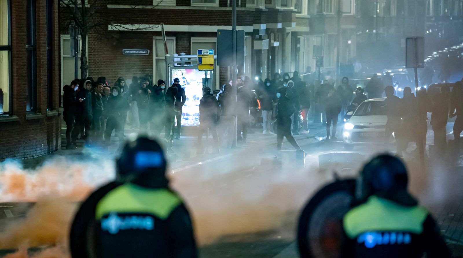 epa08965126 A large group of young people seeks confrontation with the police and pelts the police present with stones and fireworks on Beijerlandselaan in Rotterdam, The Netherlands, 25 January 2021. Police's mobile unit is present and has carried out charges to clear the street. Some arrests have also been made and a water cannon has been used. Nationwide protest against coronavirus restrictions and curfew imposed by Dutch government broke out during the weekend in many Dutch cities, leading to some violent riots and clashes with Police.  EPA/KILLIAN LINDENBURG / MEDIATV