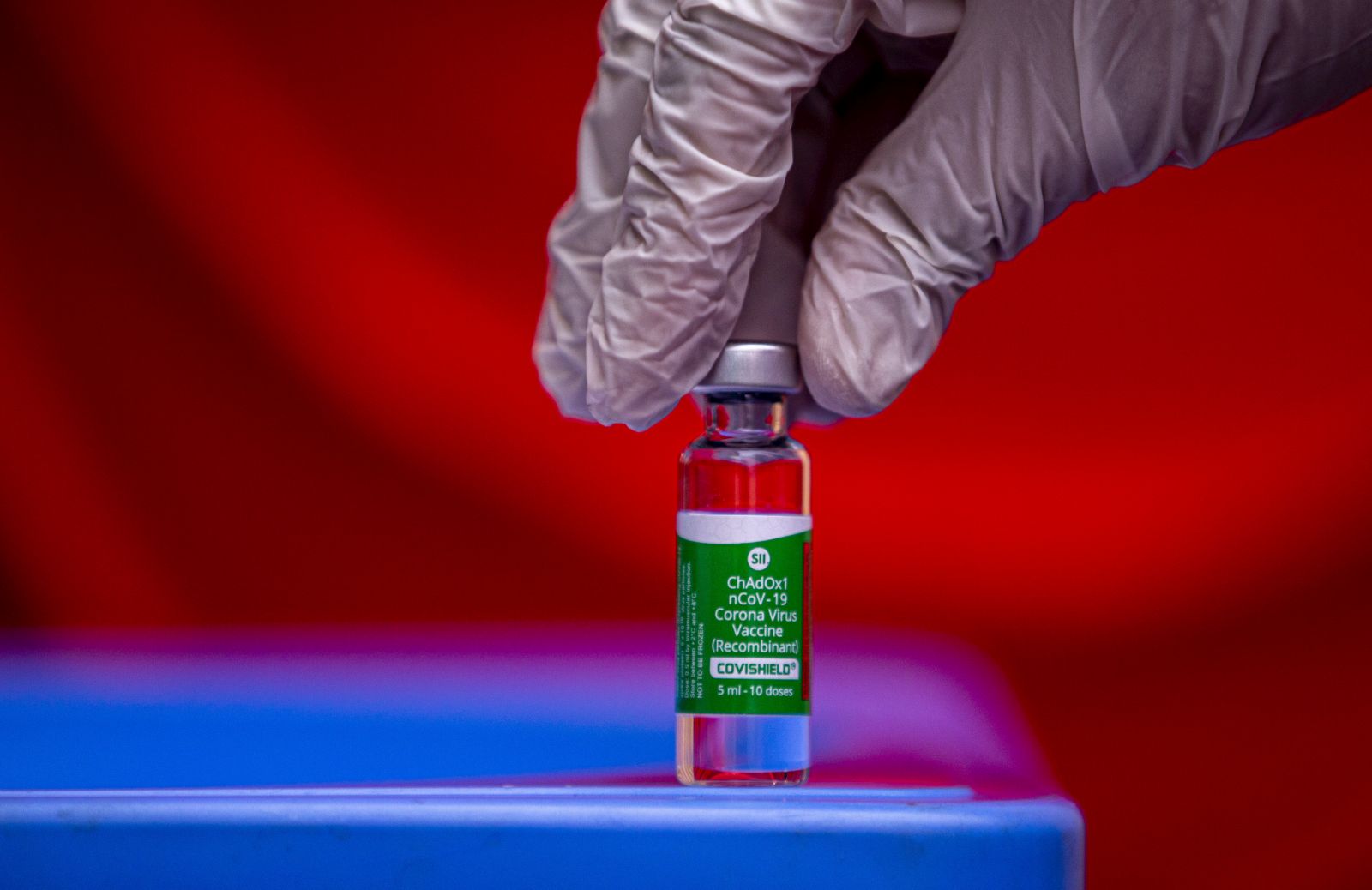 epa08967890 A health worker holds a vial of Covishield COVID-19 vaccine at Patan hospital in Lalitpur, Nepal, 27 January 2021. One million doses of Covishield, the Oxford-AstraZeneca vaccine manufactured by the Serum Institute of India (SII), was shipped to neighboring Nepal amid the ongoing coronavirus pandemic.  EPA/NARENDRA SHRESTHA