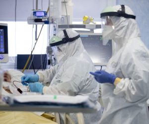 epa08968678 Health workers wearing personal protective equipment (PPE) work inside the intensive care unit (ICU) of the San Filippo Neri Hospital in Rome, Italy, 27 January 2021, where patients infected with the coronavirus disease (COVID-19) are treated.  EPA/MASSIMO PERCOSSI -- ATTENTION EDITORS: FACE OF THE PATIENT PIXELATED AT SOURCE