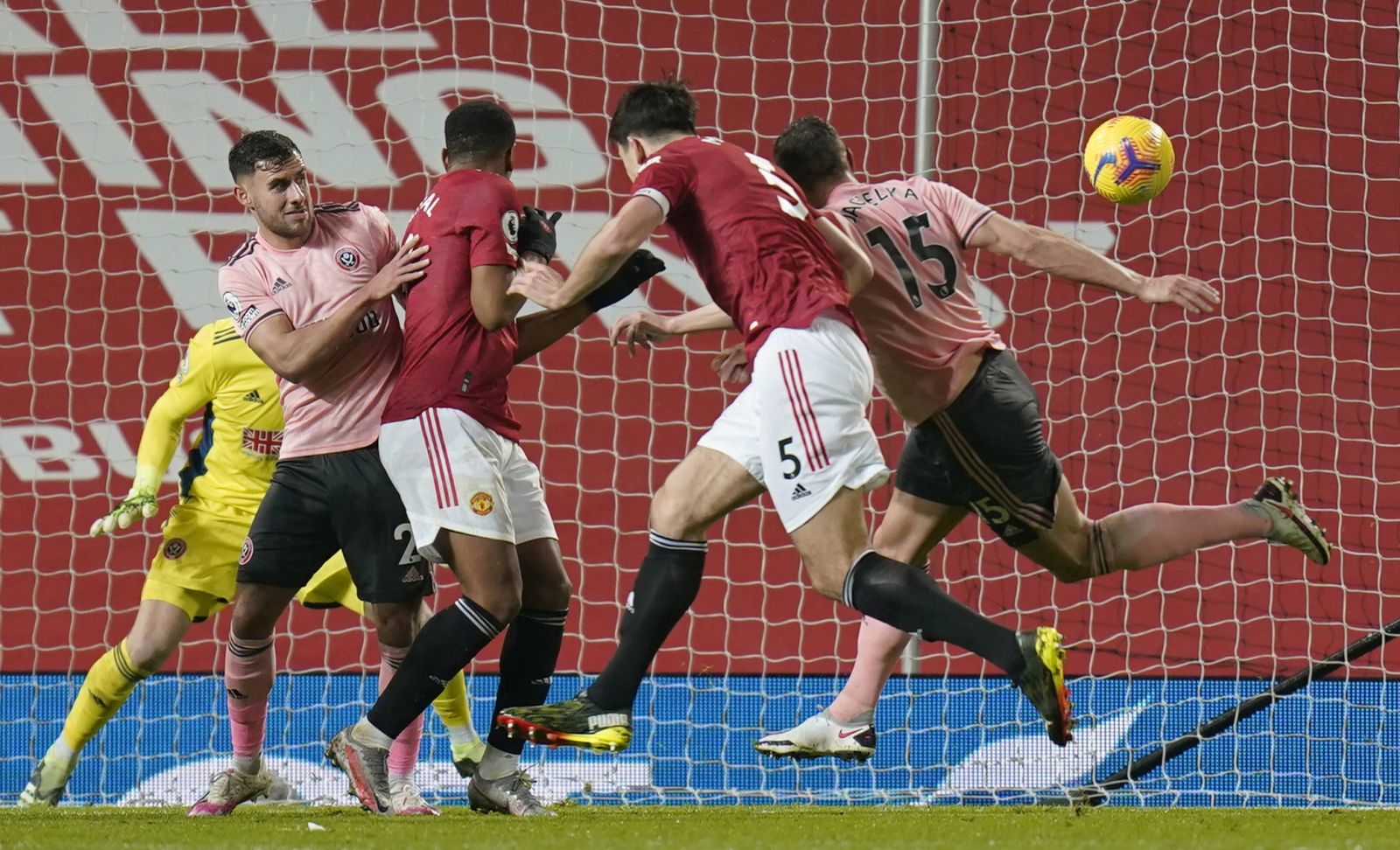 epa08969944 Harry Maguire of Manchester United (C) scores his team's opening goal during the English Premier League soccer match between Manchester United and Sheffield United in Manchester, Britain, 27 January 2021.  EPA/Tim Keeton / POOL EDITORIAL USE ONLY. No use with unauthorized audio, video, data, fixture lists, club/league logos or 'live' services. Online in-match use limited to 120 images, no video emulation. No use in betting, games or single club/league/player publications.