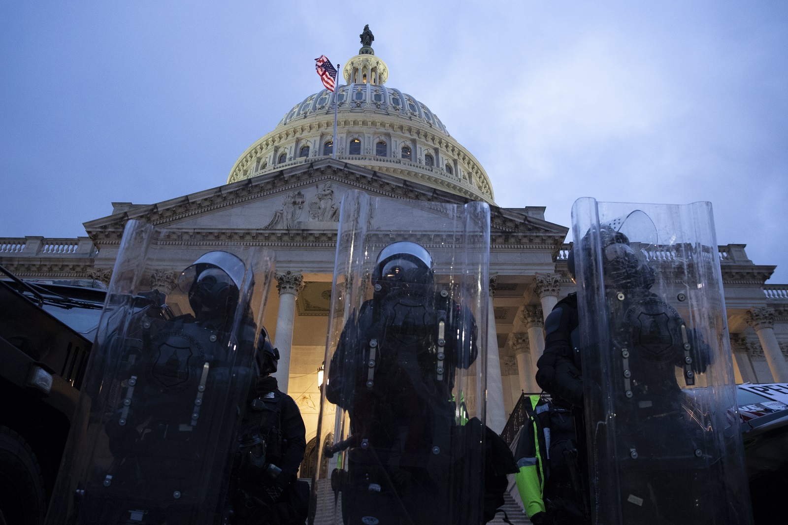 epa08923720 Police stand outside the East Front of the US Capitol at dusk as a curfew begins after pro-Trump protesters stormed the grounds leading to chaos, in Washington, DC, USA, 06 January 2021. Various groups of Trump supporters have broken into the US Capitol and rioted as Congress prepares to meet and certify the results of the 2020 US Presidential election.  EPA/MICHAEL REYNOLDS