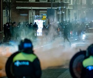 epa08965126 A large group of young people seeks confrontation with the police and pelts the police present with stones and fireworks on Beijerlandselaan in Rotterdam, The Netherlands, 25 January 2021. Police's mobile unit is present and has carried out charges to clear the street. Some arrests have also been made and a water cannon has been used. Nationwide protest against coronavirus restrictions and curfew imposed by Dutch government broke out during the weekend in many Dutch cities, leading to some violent riots and clashes with Police.  EPA/KILLIAN LINDENBURG / MEDIATV