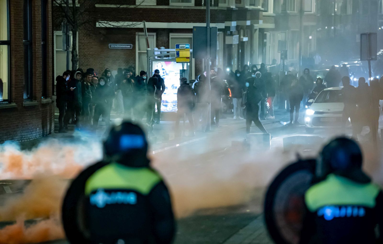 epa08965126 A large group of young people seeks confrontation with the police and pelts the police present with stones and fireworks on Beijerlandselaan in Rotterdam, The Netherlands, 25 January 2021. Police's mobile unit is present and has carried out charges to clear the street. Some arrests have also been made and a water cannon has been used. Nationwide protest against coronavirus restrictions and curfew imposed by Dutch government broke out during the weekend in many Dutch cities, leading to some violent riots and clashes with Police.  EPA/KILLIAN LINDENBURG / MEDIATV
