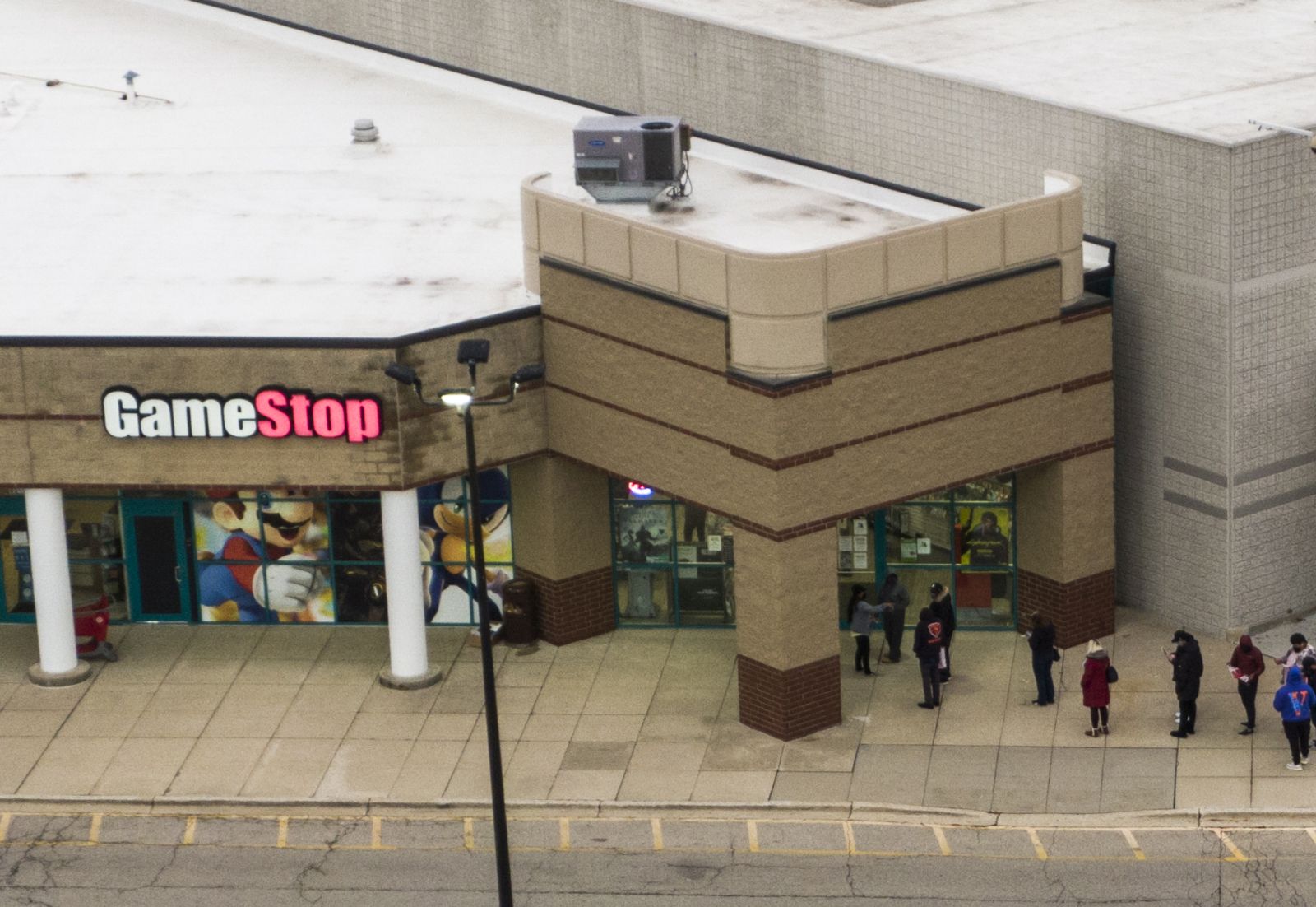 epa08969952 (FILE) - An aerial photo made with a drone shows customers lined up outside a GameStop electronics store on Black Friday in Gurnee, Illinois, USA, 27 November 2020 (reissued 27 January 2021.) The electronic game retailer has seen it's stock price soar from 3.25 US dollars in April 2020 to close at 347.51 US dollars on 27 January. The company has drawn interest from investors in online chat groups and created as much as 3 billion US dollars in value losses for short sellers.  EPA/TANNEN MAURY