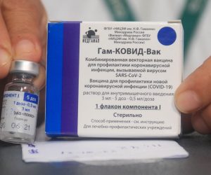epa08973818 A nurse shows the vaccine against covid-19 to apply it to doctors and health workers, after the arrival of the first 20,000 doses of the Russian Sputnik V, at the Japanese Hospital of Santa Cruz, Bolivia, 29 January 2021. The nurse with sixteen years of experience in the intensive care area was the first to receive the vaccine, which was also applied to more than a dozen 'front line' medical officials in the face of the pandemic.  EPA/JUAN CARLOS TORREJON