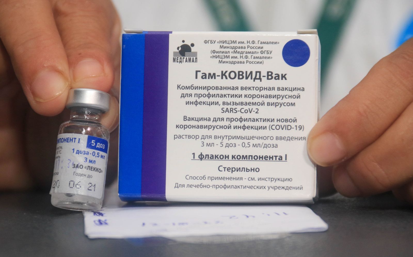 epa08973818 A nurse shows the vaccine against covid-19 to apply it to doctors and health workers, after the arrival of the first 20,000 doses of the Russian Sputnik V, at the Japanese Hospital of Santa Cruz, Bolivia, 29 January 2021. The nurse with sixteen years of experience in the intensive care area was the first to receive the vaccine, which was also applied to more than a dozen 'front line' medical officials in the face of the pandemic.  EPA/JUAN CARLOS TORREJON