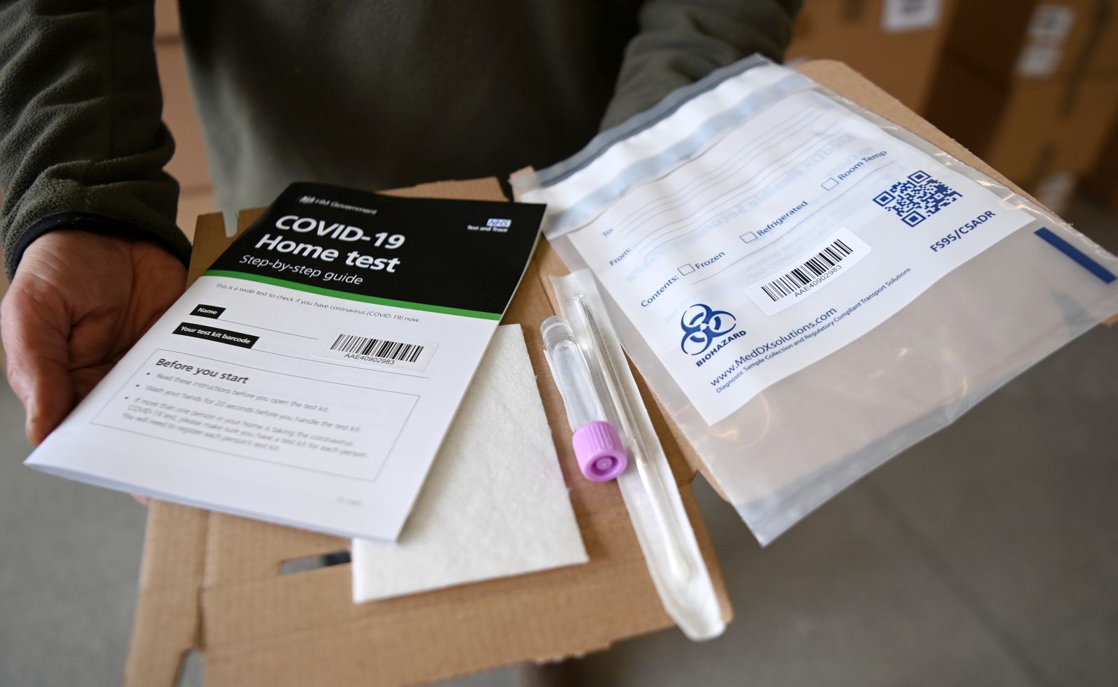 epa08981515 A Covid-19 home test kit is displaued at Woking Fire Station in Woking, Britain, 02 February 2021. Door-to-door testing of some eighty thousand people is underway in England to find cases of the South Africa coronavirus variant. Eleven cases were discovered in people with no links to travel or previous cases of the strain. British Health Secretary Matt Hancock stated it is 'on all of us' to contain the new variant, which is feared to be spreading in communities.  EPA/ANDY RAIN