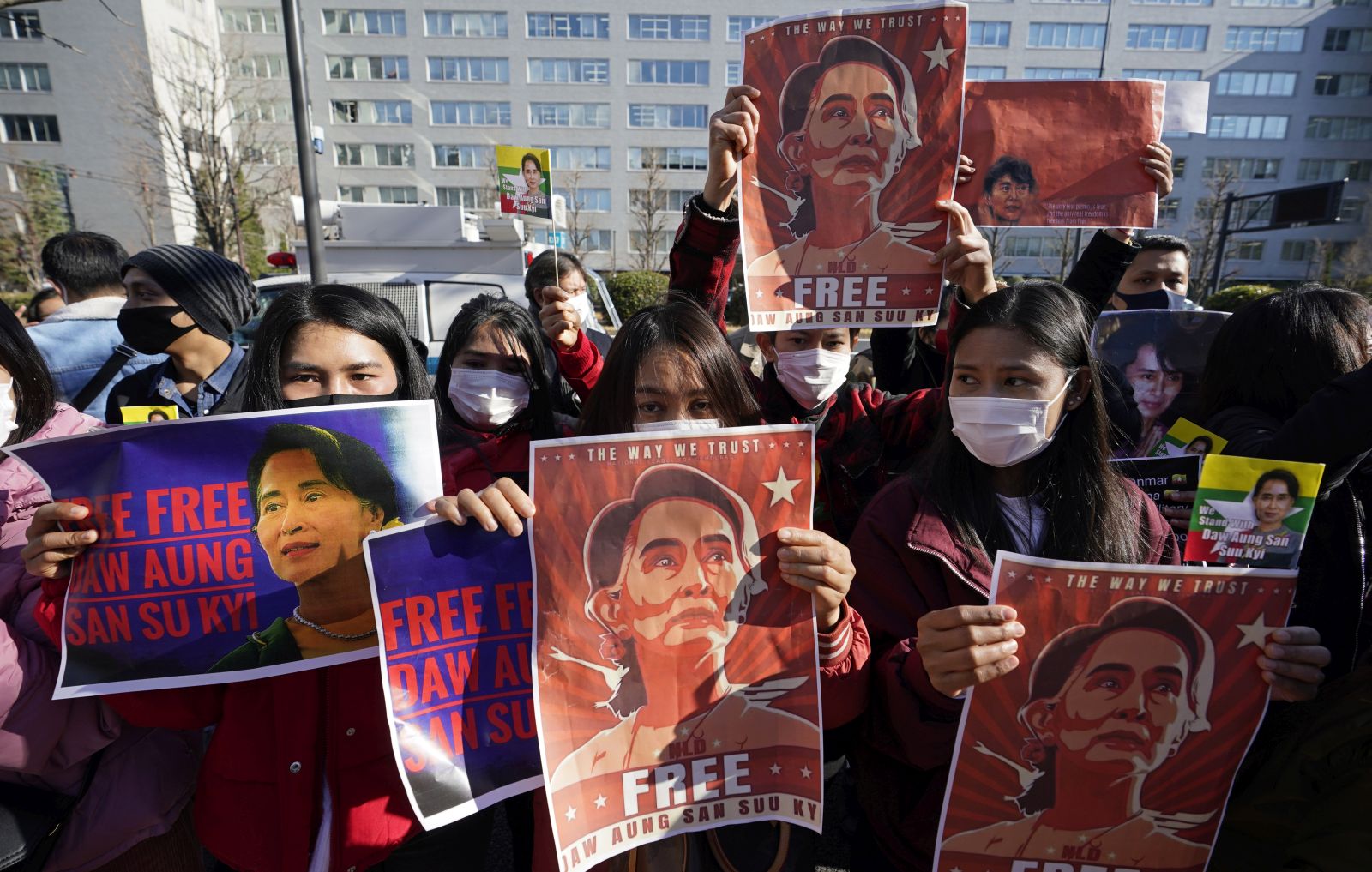 epa08983416 Myanmar nationals in Japan hold up portraits of Aung San Suu Kyi during a protest held in front of Japan’s Foreign Ministry in Tokyo, Japan, 03 February 2021. Myanmar's military seized power and declared a state of emergency for one year after arresting State Counselor Aung San Suu Kyi and Myanmar president Win Myint in an early morning raid on 01 February, following increasing tension over the result of last November's parliamentary elections.  EPA/FRANCK ROBICHON