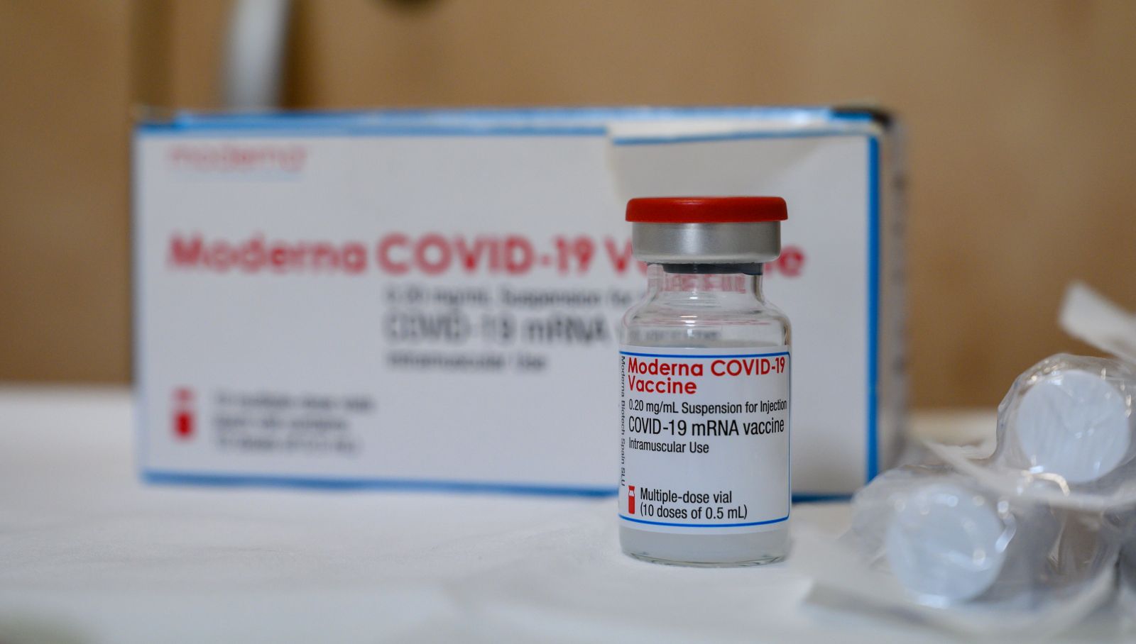 epa08988847 A view of a vial of COVID-19 vaccine manufactured by the US biotechnology company Moderna in the surgery of general practitioner Janos Plavecz in Tatabanya, Hungary, 05 February 2021. The nationwide inoculation of people in the oldest age group, who registered to receive a jab, was launched on 04 February 2021.  EPA/TAMAS VASVARI HUNGARY OUT