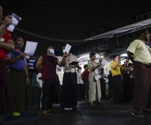 epa08989279 Myanmar people sing resistance songs at a street as a symbol of resistance against the military coup at the downtown area in Yangon, Myanmar, 05 February 2021. People in Yangon hit pots and pans together producing noise (that sound is believed to drive the evils away in Burmese tradition) at 8:00 PM local time as a symbol of resistance to the recent military coup. Myanmar's Aung San Suu Kyi and other top political leaders were detained in a military coup on 01 February amid allegations of voter fraud in the November 2020 elections.  EPA/LYNN BO BO