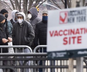 epa08989939 People wait in line for a COVID-19 vaccination appointment at a vaccination site set up in Yankees Stadium in the Bronx borough of New York, New York, USA, 05 February 2021. New York, and states around the country are trying to ramp up their distribution of the COVID-19 vaccine.  EPA/JUSTIN LANE