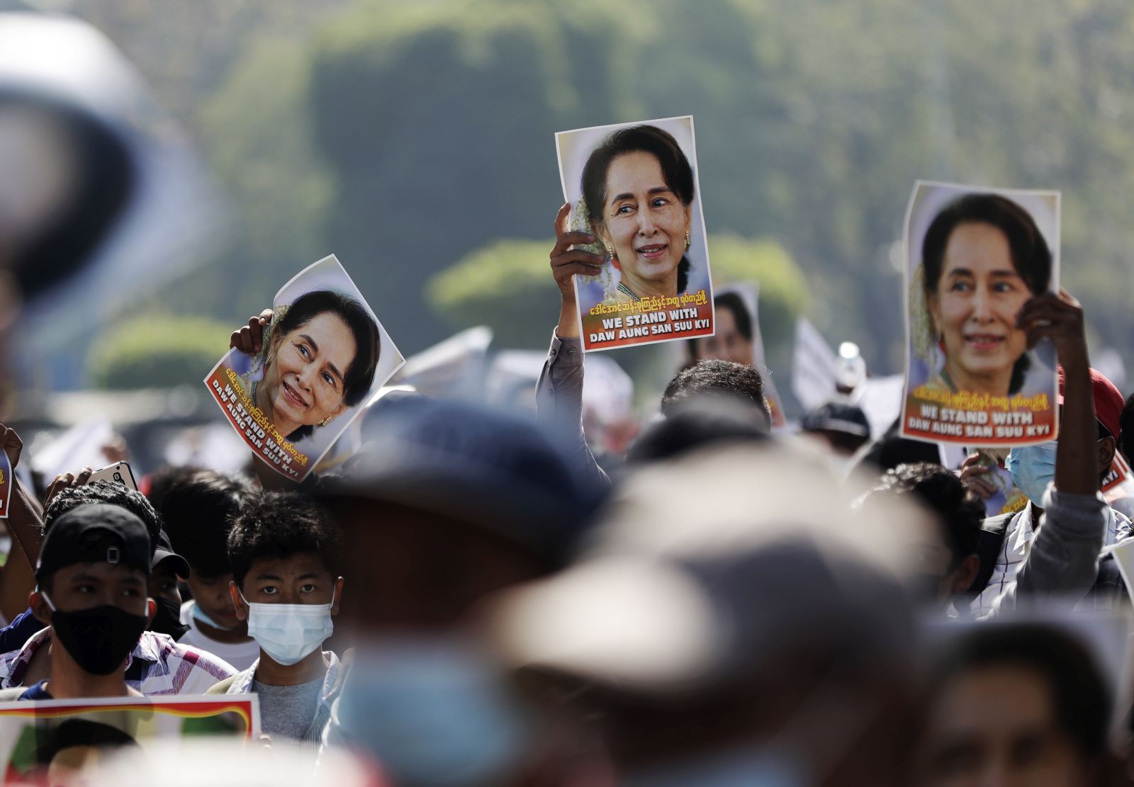 epa08997753 Demonstrators hold up pictures of detained Myanmar State Counselor Aung San Suu Kyi during a protest against the military coup, in Yangon, Myanmar, 09 February 2021. Thousands of people continued to rally in Yangon despite stern warnings from the military after days of mass protests. Orders were issued on 08 February in major cities and townships banning people from protesting or gathering in groups of more than five. A nighttime curfew was also imposed. Myanmar's military seized power and declared a state of emergency for one year after arresting State Counselor Aung San Suu Kyi, the country's president and other political figures in an early morning raid on 01 February.  EPA/LYNN BO BO