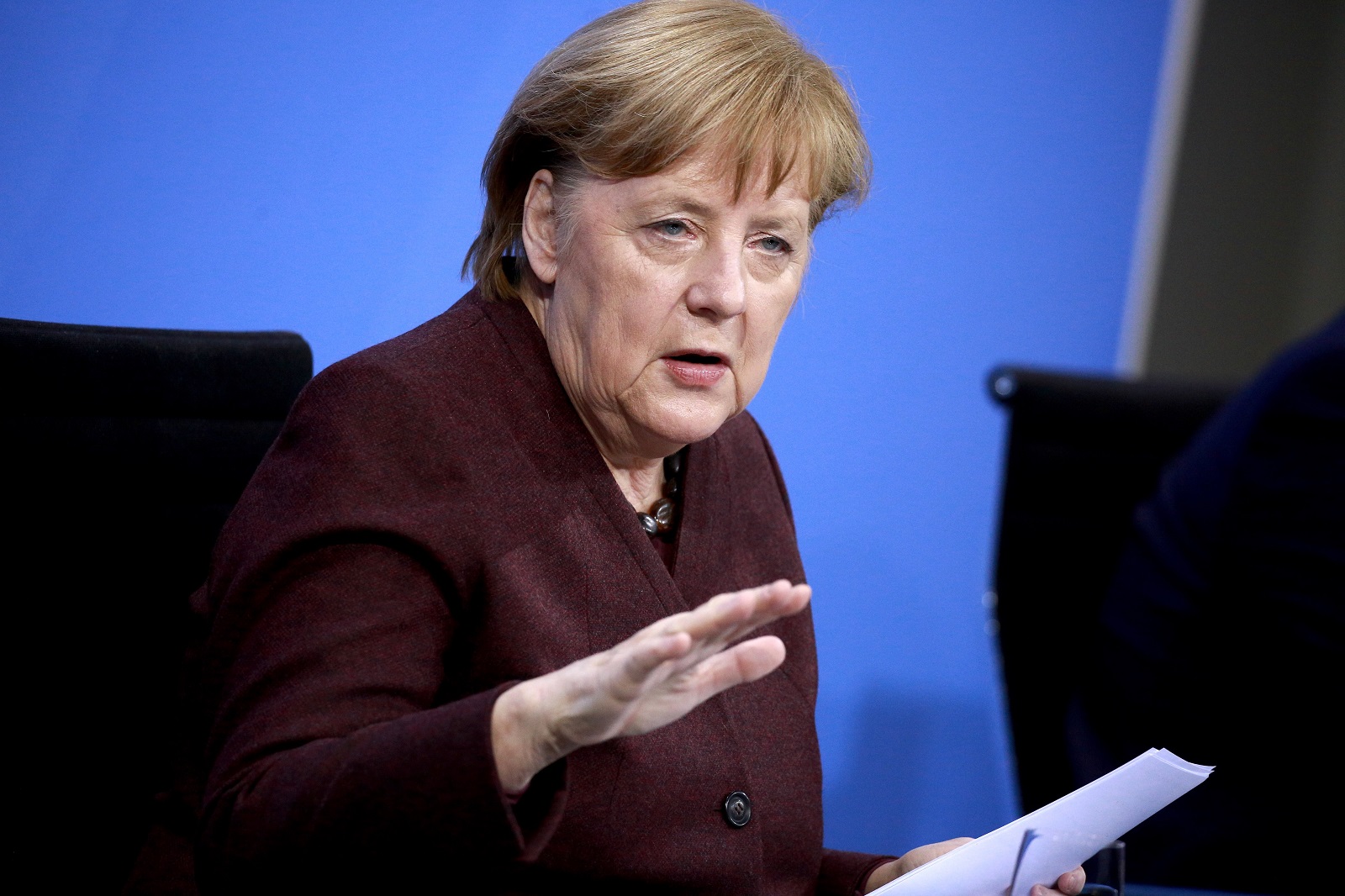 epa09002137 German Chancellor Angela Merkel speaks at a press conference after a video conference with German State Premiers about the current coronavirus situation, at the Chancellery in Berlin, Germany, 10 February 2021.  EPA/CHRISTIAN MARQUARDT / POOL