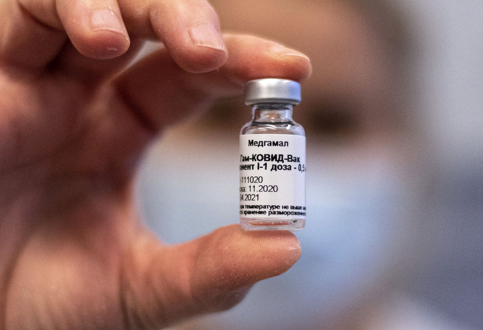 epa09006876 A vial containing Russian vaccine Sputnik V is shown by a nurse at Central Hospital of the Hungarian Defence Forces (military) in Budapest, Hungary, 12 February 2021 as the vaccination with Sputnik V agains covid-19 begins in the country.  EPA/ZSOLT SZIGETVARY HUNGARY OUT