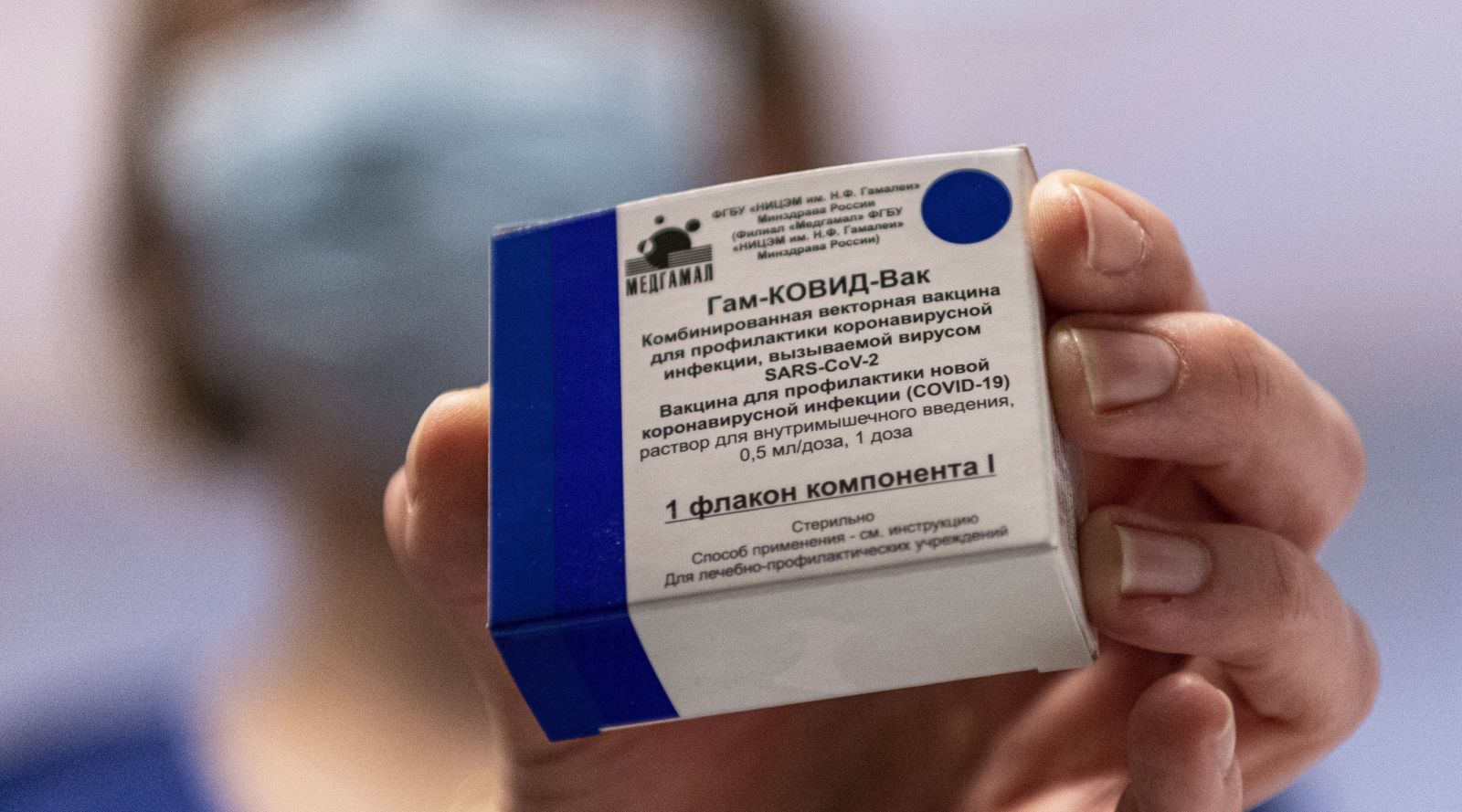 epa09006873 A box containing Russian vaccine Sputnik V is shown by a nurse at Central Hospital of the Hungarian Defence Forces (military) in Budapest, Hungary, 12 February 2021 as the vaccination with Sputnik V agains covid-19 begins in the country.  EPA/ZSOLT SZIGETVARY HUNGARY OUT