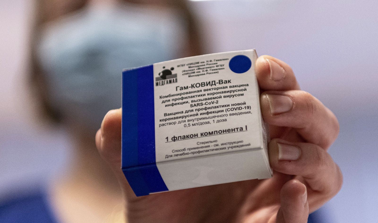epa09006873 A box containing Russian vaccine Sputnik V is shown by a nurse at Central Hospital of the Hungarian Defence Forces (military) in Budapest, Hungary, 12 February 2021 as the vaccination with Sputnik V agains covid-19 begins in the country.  EPA/ZSOLT SZIGETVARY HUNGARY OUT