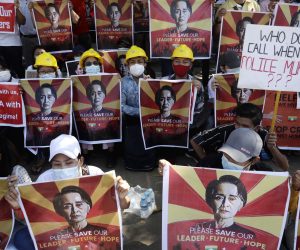epa09008439 Protesters hold placards calling for the release of detained Myanmar State Counselor Aung San Suu Kyi during a protest against the military coup outside the Chinese Embassy in Yangon, Myanmar, 13 February 2021. People continued to rally across the country despite orders banning mass gatherings and reports of increasing use of force by police against anti-coup protesters. Myanmar's military seized power and declared a state of emergency for one year after arresting State Counselor Aung San Suu Kyi and Myanmar president Win Myint in an early morning raid on 01 February.  EPA/LYNN BO BO