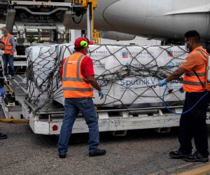 epa09010566 Airport personnel unload boxes with the Sputnik V vaccines at the Maiquetia International Airport, near Caracas, Venezuela, 13 February 2021. A first batch of the Russian Sputnik V vaccine against covid-19 arrived on 13 February at the Maiquetía International Airport, which serves Caracas, on a plane from Moscow of the Venezuelan state airline Conviasa, as part of the contract established between Venezuela and Russia for ten million doses.  EPA/RAYNER PEÑA R