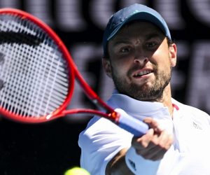 epa09015333 Aslan Karatsev of Russia in action during his Quarterfinals Men's singles match against Grigor Dimitrov of Bulgaria on Day 9 of the Australian Open Grand Slam tennis tournament at Melbourne Park in Melbourne, Australia, 16 February 2021.  EPA/DEAN LEWINS AUSTRALIA AND NEW ZEALAND OUT