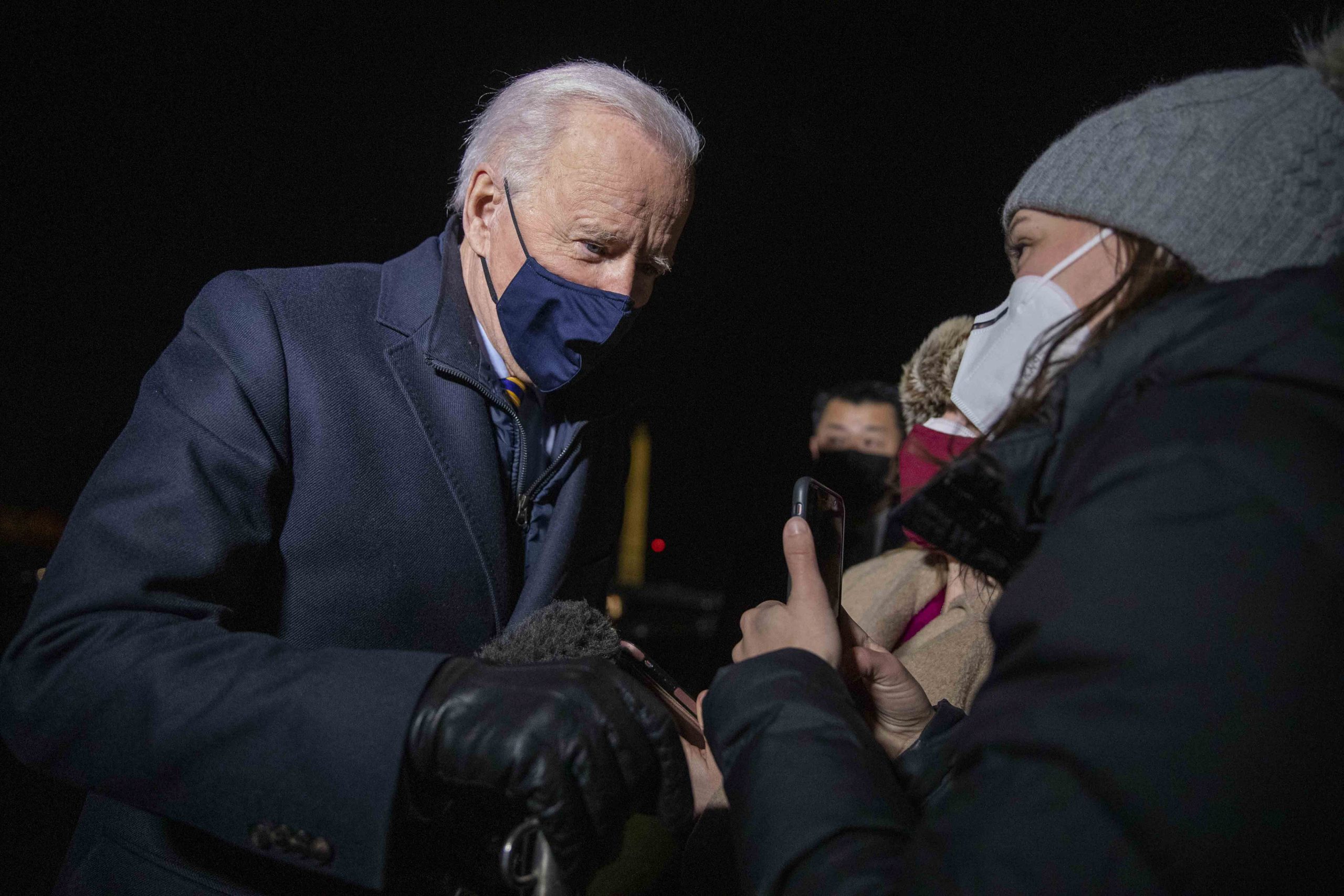 epa09017413 US President Joe Biden (L) responds to a question from a journalist as he steps off Marine One on the South Lawn of the White House in Washington, DC, USA, 17 February 2021. President Biden returned to the White House following a town hall meeting.  EPA/SHAWN THEW