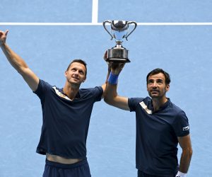 epa09027093 Filip Polasek (L) of Slovakia and Ivan Dodig (R) of Croatia pose for photographs with the winners trophy after winning their men's doubles finals match against Rajeev Ram of the USA and Joe Salisbury of Britain at the Australian Open grand slam tennis tournament at Melbourne Park in Melbourne, Australia, 21 February 2021.  EPA/DEAN LEWINS  AUSTRALIA AND NEW ZEALAND OUT