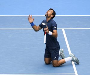 epa09027087 Ivan Dodig of Croatia celebrates after winning the men's doubles finals match with partner Filip Polasek of Slovakia against Rajeev Ram of the USA and Joe Salisbury of Britain at the Australian Open grand slam tennis tournament at Melbourne Park in Melbourne, Australia, 21 February 2021.  EPA/DEAN LEWINS  AUSTRALIA AND NEW ZEALAND OUT