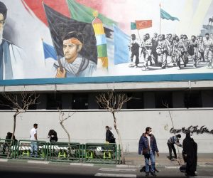 epa09030942 Iranians walk under a wall painting of Iranian supreme leader Ayatollah Ali Khamenei (Top-L) in Tehran, Iran, 23 February 2021. According to the law passed by the Iranian parliament earlier, Iranian government stopped extra inspection from its nuclear facilities by IAEA inspectors as of 23 February 2021 for three months until they reach a new agreement by lifting the US sanctions. IAEA chief Rafael Grossi said a temporary agreement was reached with Iranian government to allow a degree of monitoring until resolving disagreements and restore the 2015 nuclear deal. Iranian supreme leader Ayatollah Khamenei said that if Iran would need to enrich uranium even to 60 percent, the country would do it for its energy system and everything in need, not for building nuclear bombs which would be against one's beliefs and Islam.  EPA/ABEDIN TAHERKENAREH