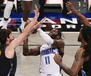 epa09037260 The Magic's James Ennis III (C) tries to score as the Nets' Joe Harris (L) and DeAndre Jordan (R) defend during the NBA basketball game between the Orlando Magic and the Brooklyn Nets at the Barclays Center in Brooklyn, New York, USA, 25 February 2021.  EPA/JUSTIN LANE SHUTTERSTOCK OUT