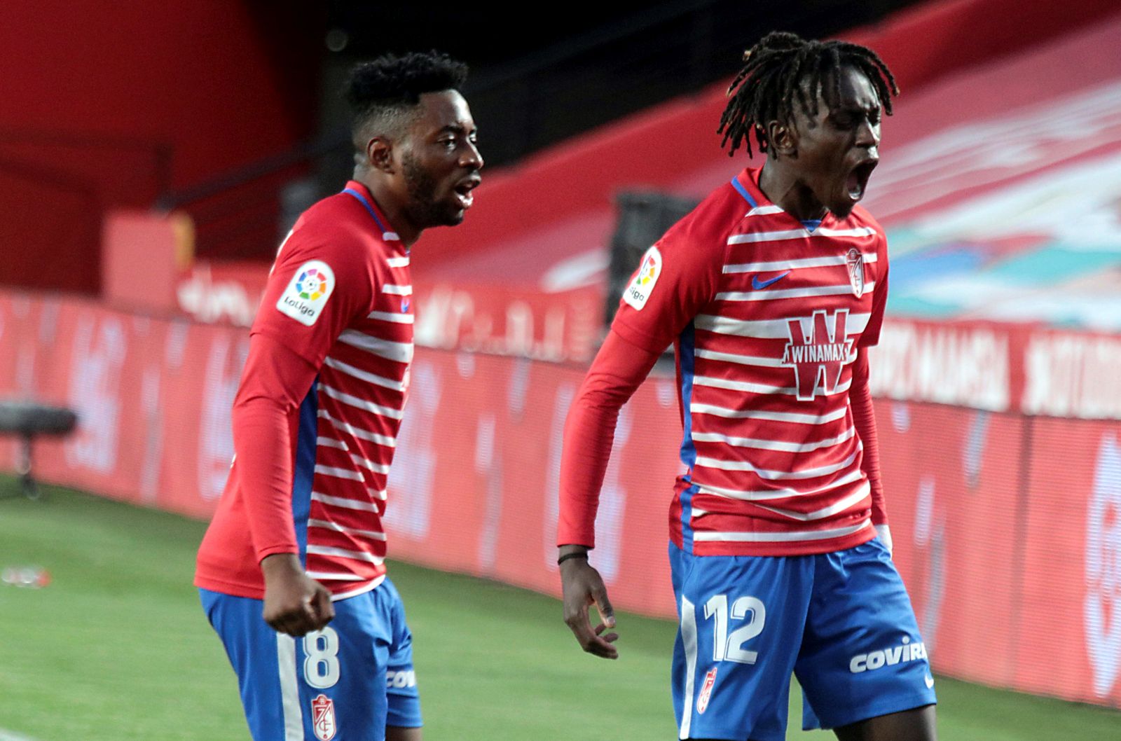 epa09043361 Granada's Domingos Quina (R) celebrates after scoring the 1-0 goal during a Spanish LaLiga soccer match between Granada CF and Elche at Nuevo Los Carmenes stadium in Granada, Spain, 28 February 2021.  EPA/PEPE TORRES