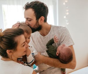 Photo of a young family with two children in their home, spending some quality time together