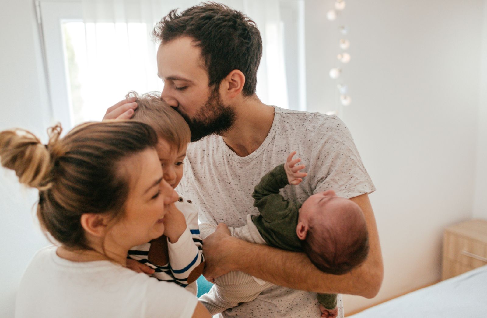 Photo of a young family with two children in their home, spending some quality time together