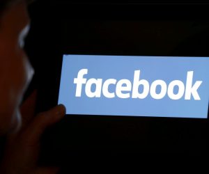 FILE PHOTO: A woman looks at the Facebook logo on an iPad in this photo illustration FILE PHOTO: A woman looks at the Facebook logo on an iPad in this photo illustration taken June 3, 2018. REUTERS/Regis Duvignau/Illustration/File Photo REGIS DUVIGNAU